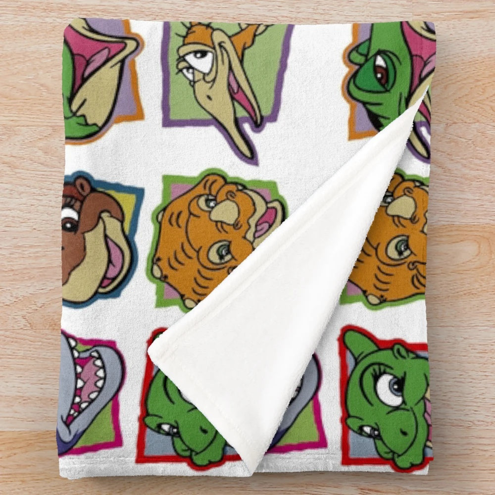 A plush blanket featuring characters from the classic 90s movie The Land Before Time