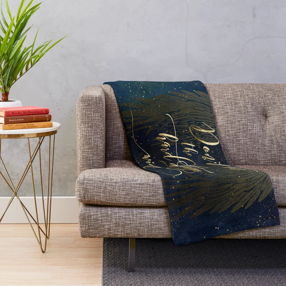A cozy plush blanket featuring a watercolor and typography design inspired by the book A Court of Mist and Fury