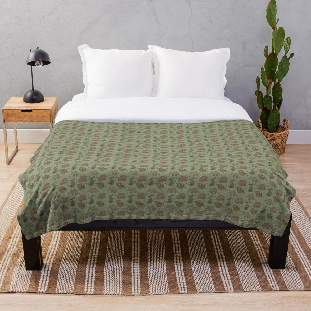 Aardvark plush blanket with a green leaf pattern