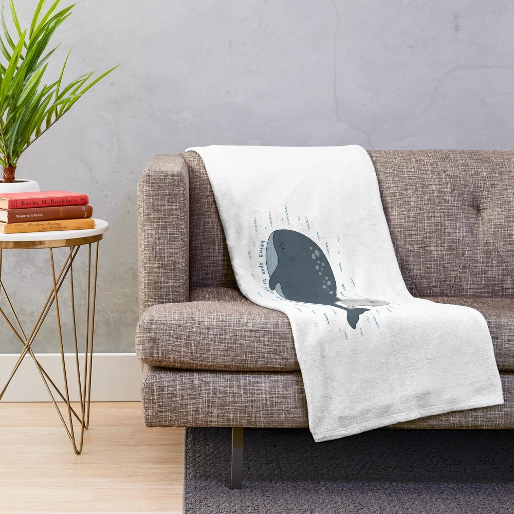 Soft and snuggly plush blanket featuring cute doodles of a seal, whale, and other marine life
