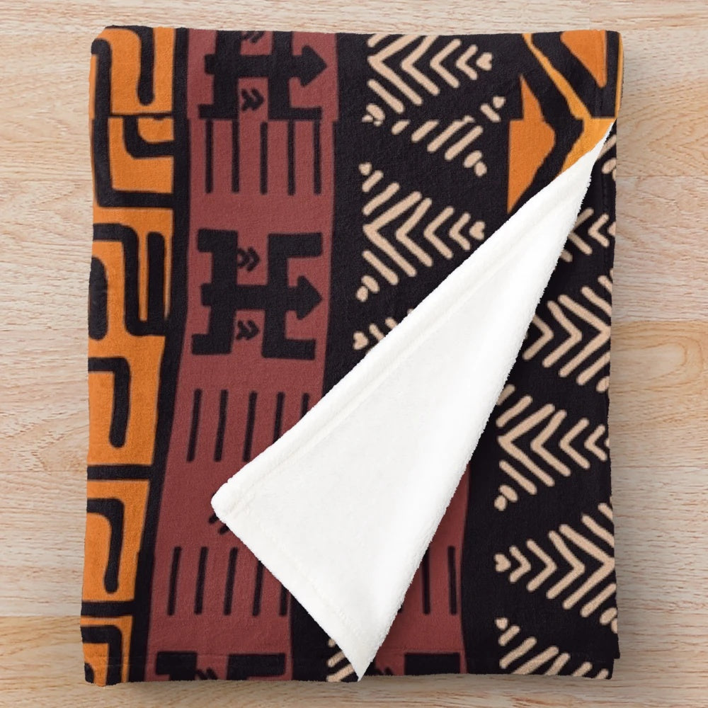 Plush blanket with an earthy, tribal African mudcloth pattern in warm, natural tones