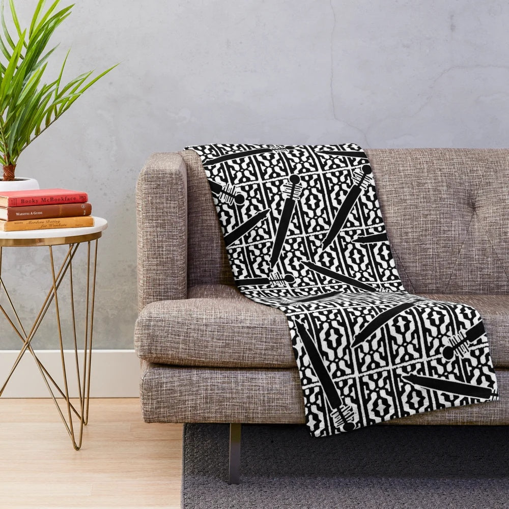 Plush blanket featuring a repeated Ainu-style pattern with scattered tonkari (traditional Japanese stringed instrument) silhouettes