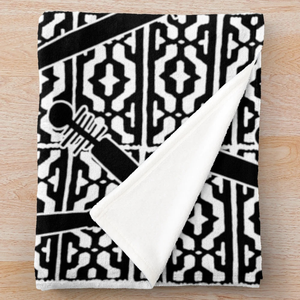 Plush blanket featuring a repeated Ainu-style pattern with scattered tonkari (traditional Japanese stringed instrument) silhouettes