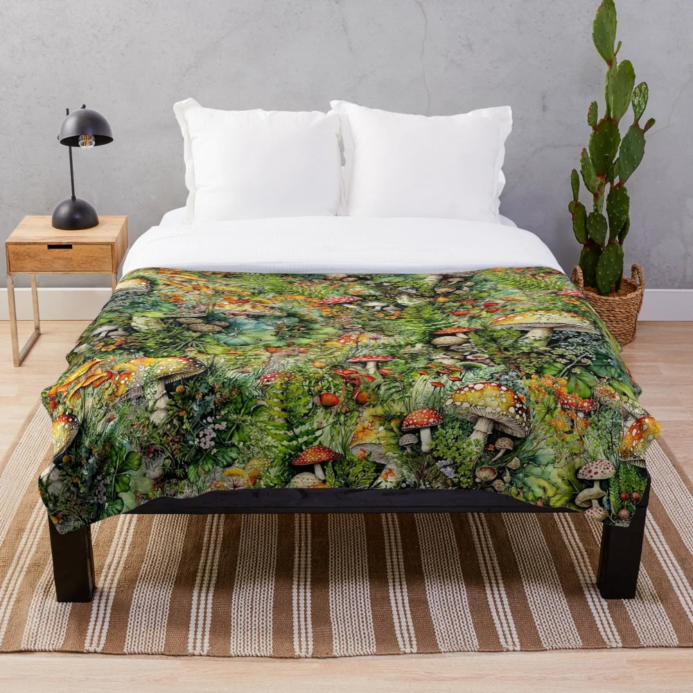 Amanita mushrooms and bright floral collage design on a plush, soft blanket