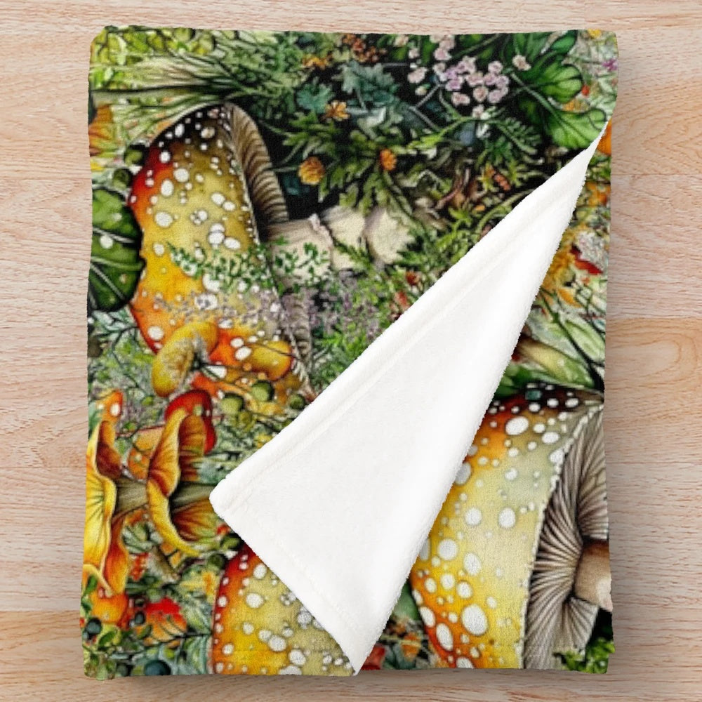 Amanita mushrooms and bright floral collage design on a plush, soft blanket