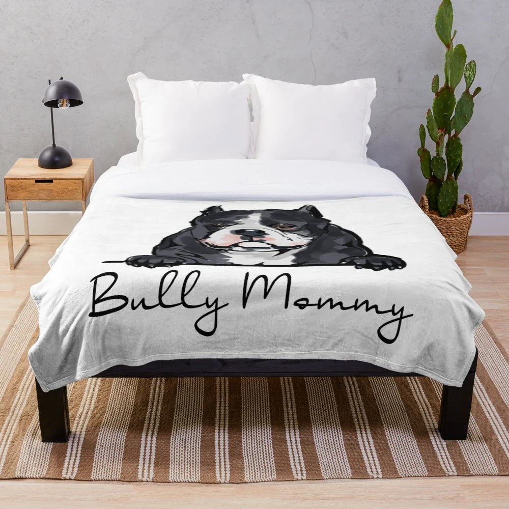 American Bully dog mom cuddling her puppy on a soft, plush blanket