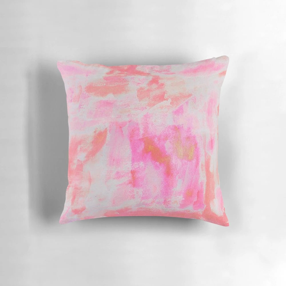 A plush and decorative pink brushed pillow with a preppy, trendy design.