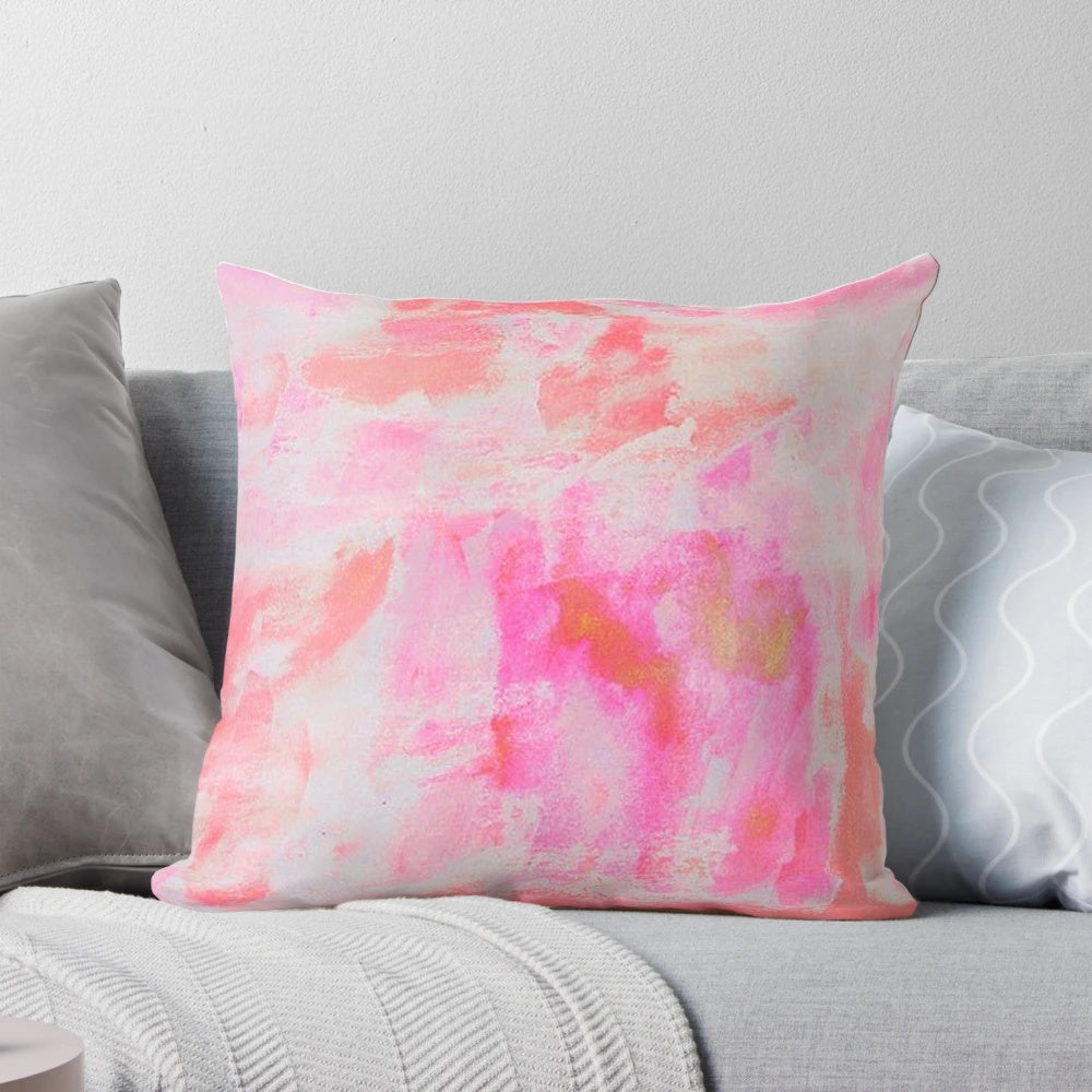 A plush and decorative pink brushed pillow with a preppy, trendy design.