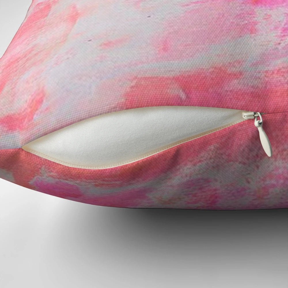 A plush and decorative pink brushed pillow with a preppy, trendy design.