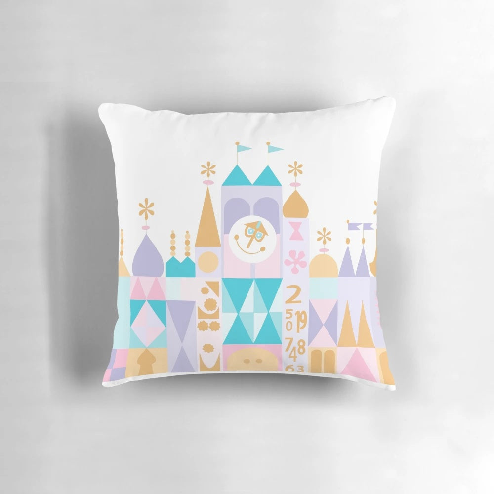 A plush, decorative pillow featuring a miniature, fantasy-inspired "small world" design.
