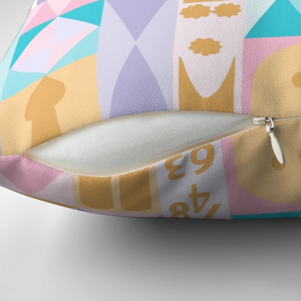 A plush, decorative pillow featuring a miniature, fantasy-inspired "small world" design.