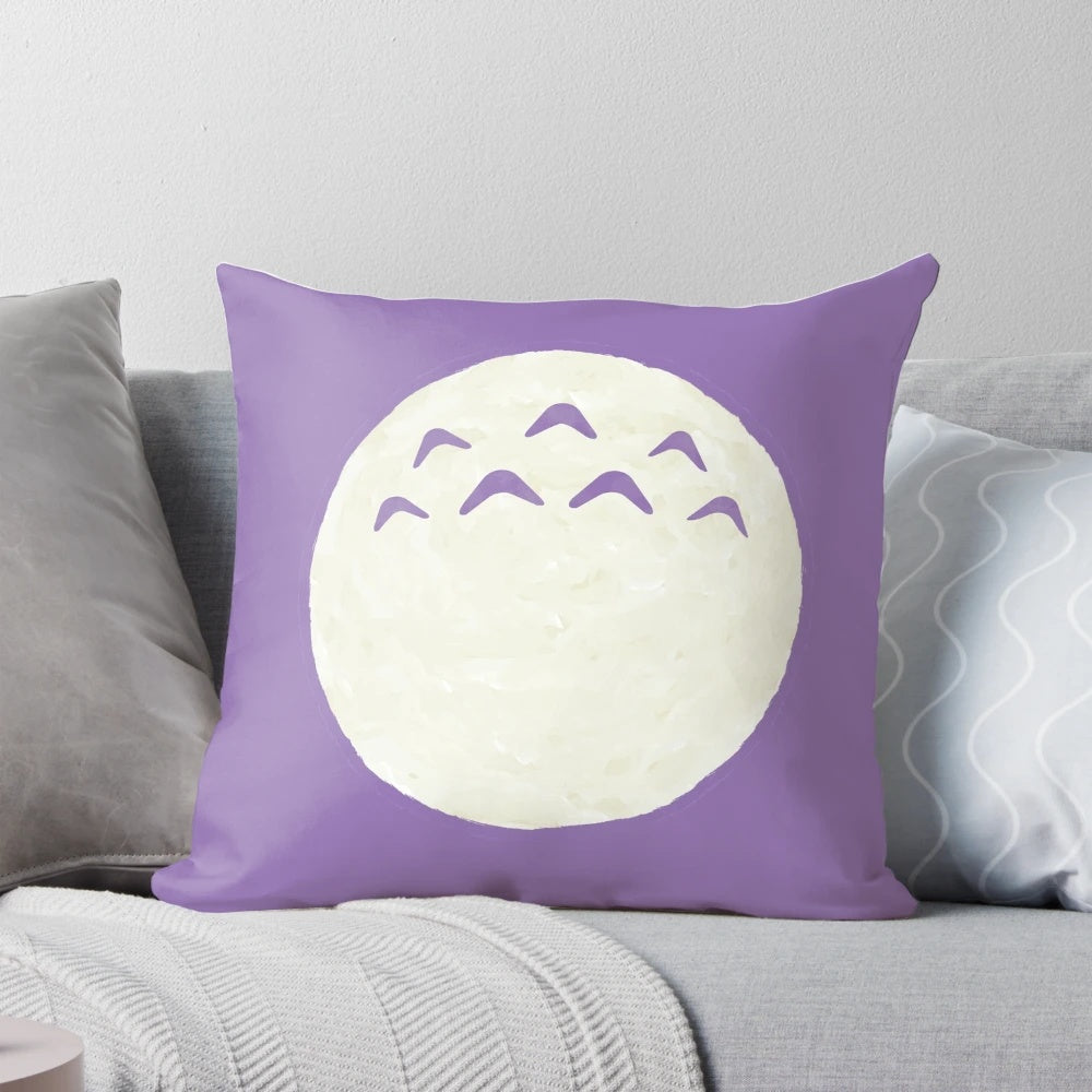 A soft, plush pillow featuring the beloved characters from the Studio Ghibli film "My Neighbor Totoro".