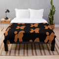 Apricot poodle on a black plush blanket