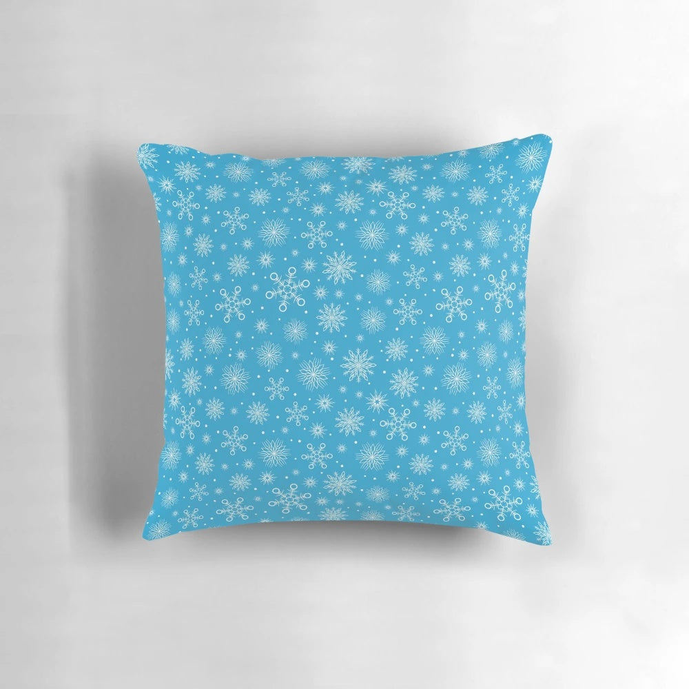 Aqua blue pillow with delicate white snowflakes, perfect for Christmas and winter home decor