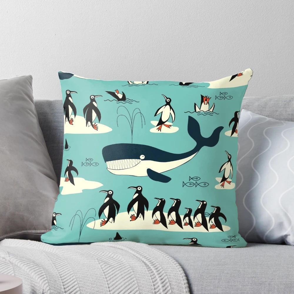 A decorative throw pillow featuring illustrations of whales, penguins, and other arctic animals.