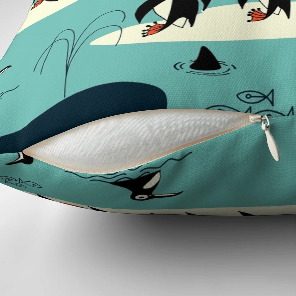 A decorative throw pillow featuring illustrations of whales, penguins, and other arctic animals.