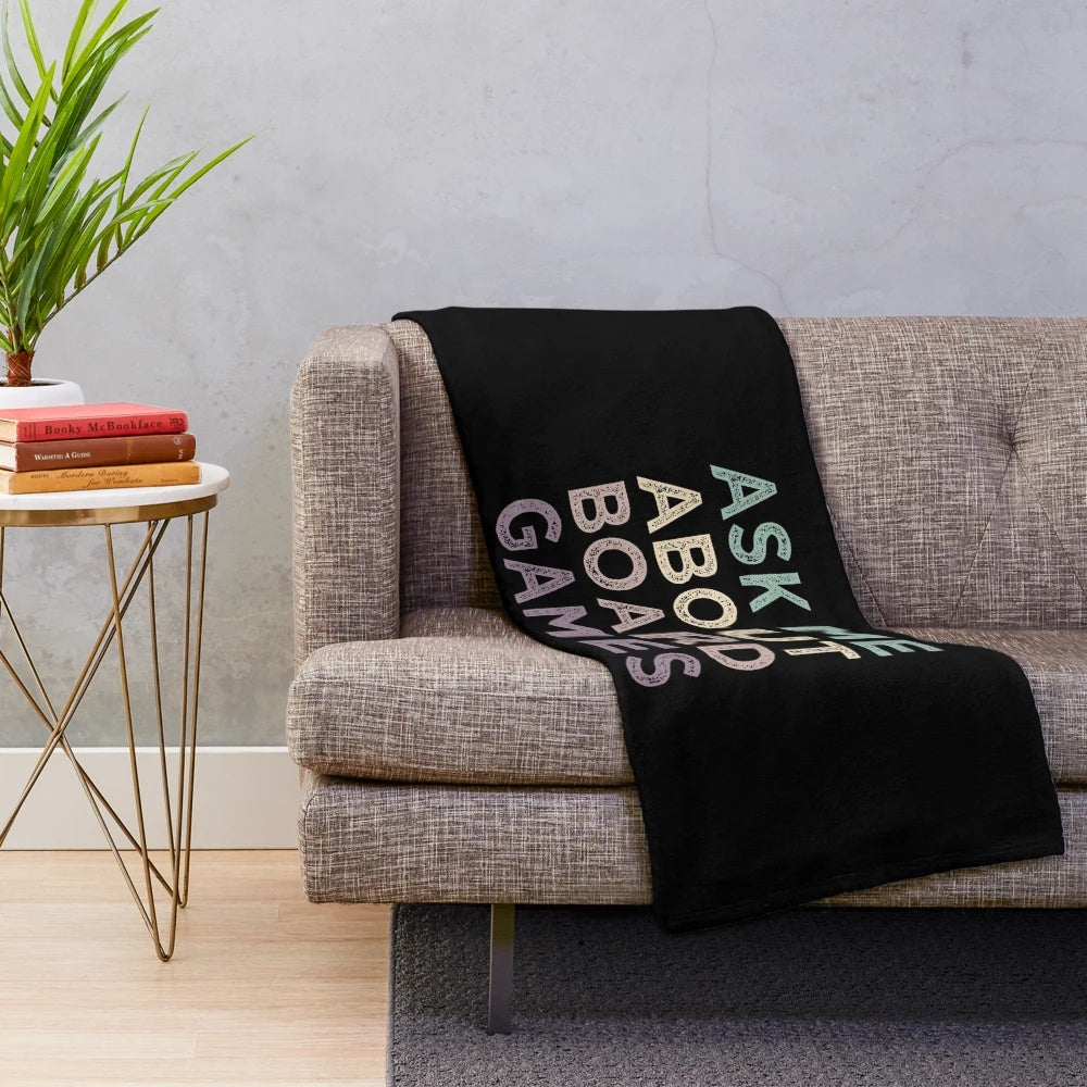 Plush blanket with "Ask Me About Board Games" design