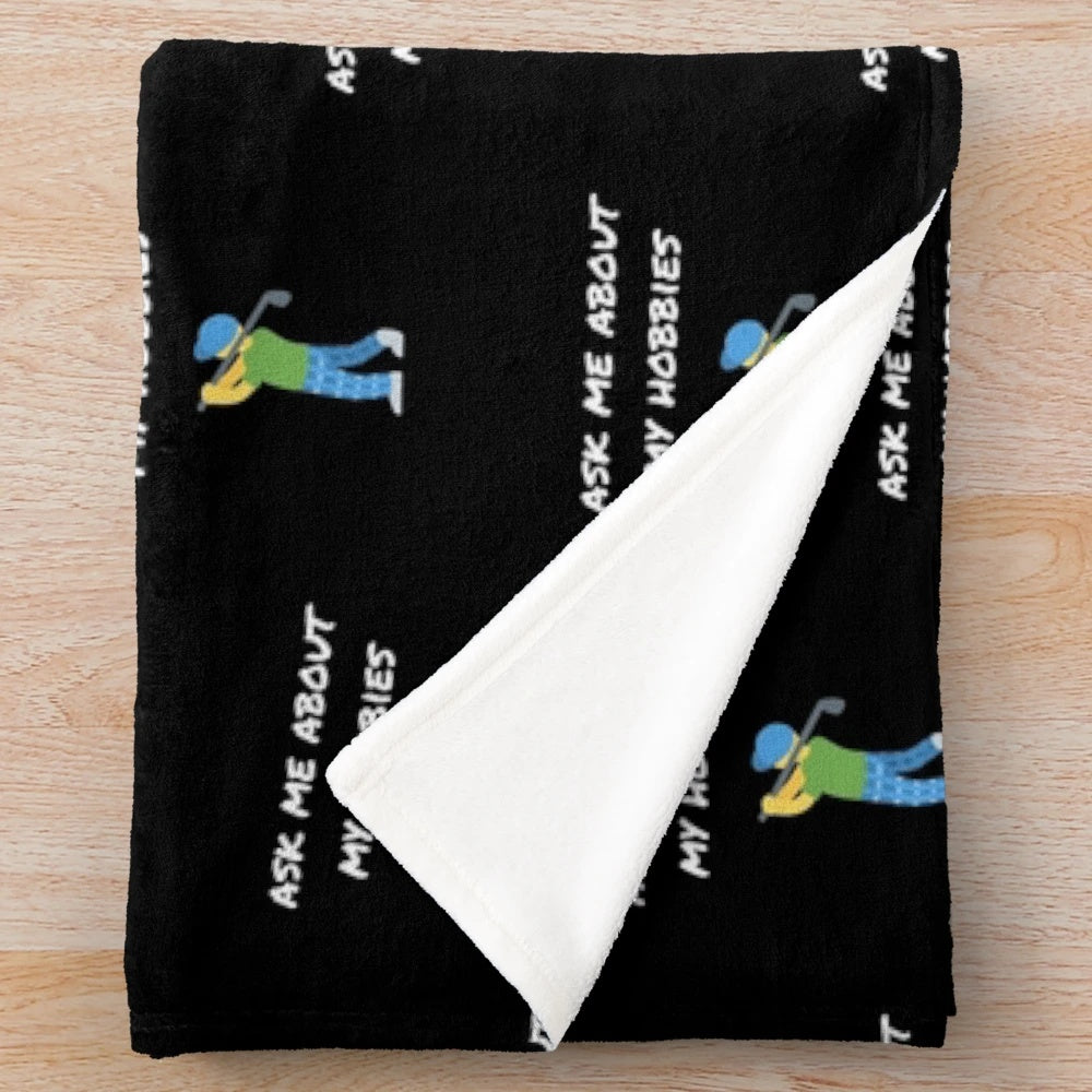 Plush blanket with "Ask me about my hobbies" design