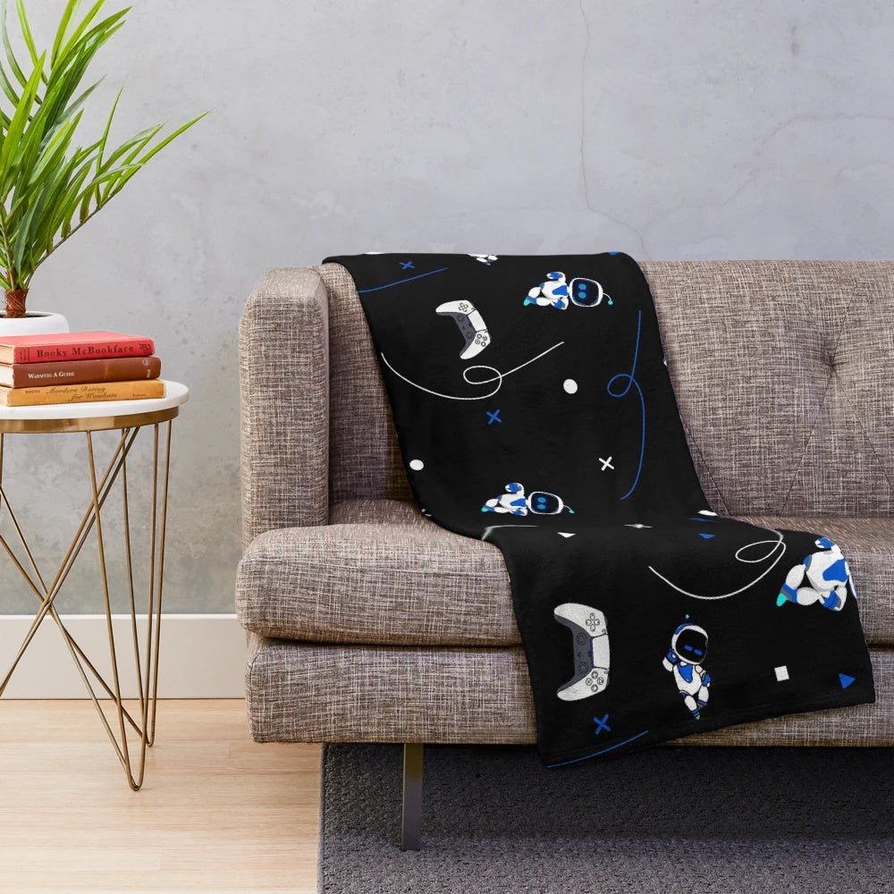 Soft and cuddly plush blanket featuring an Astrobot-inspired pattern, perfect for PlayStation 5 fans.