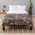 Plush blanket featuring illustrated Australian animals like kangaroos and cockatoos
