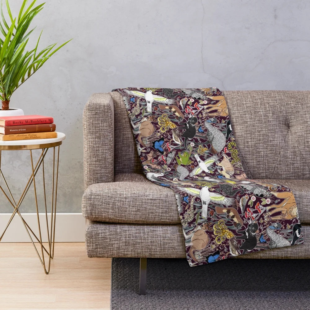 Plush blanket featuring illustrated Australian animals like kangaroos and cockatoos