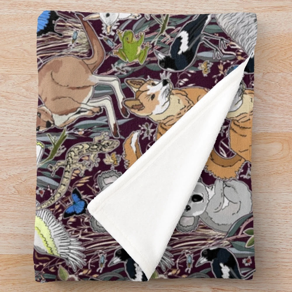 Plush blanket featuring illustrated Australian animals like kangaroos and cockatoos