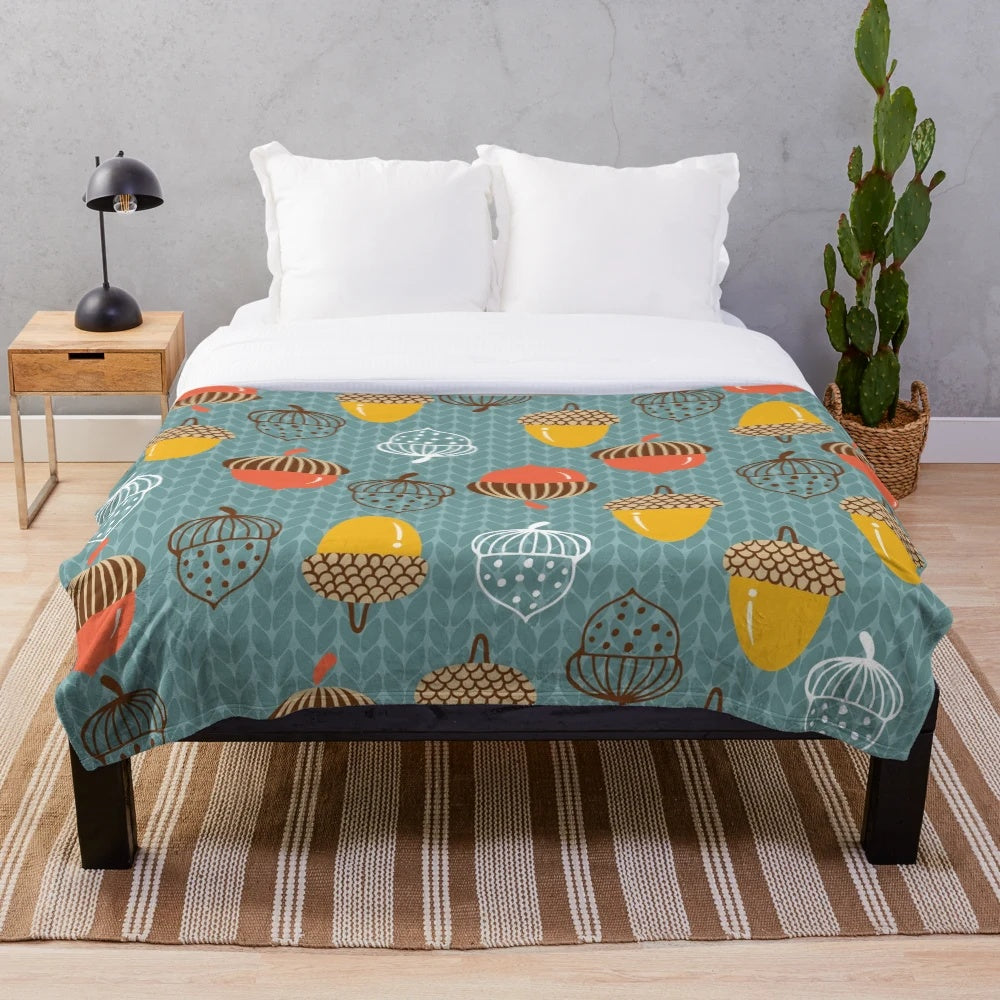 Cozy plush blanket featuring a pattern of autumn acorns