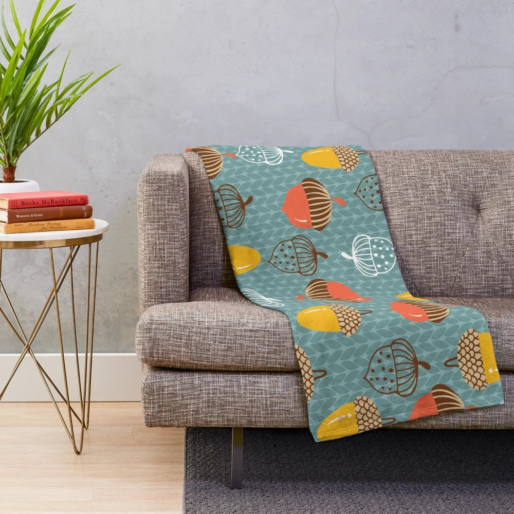Cozy plush blanket featuring a pattern of autumn acorns