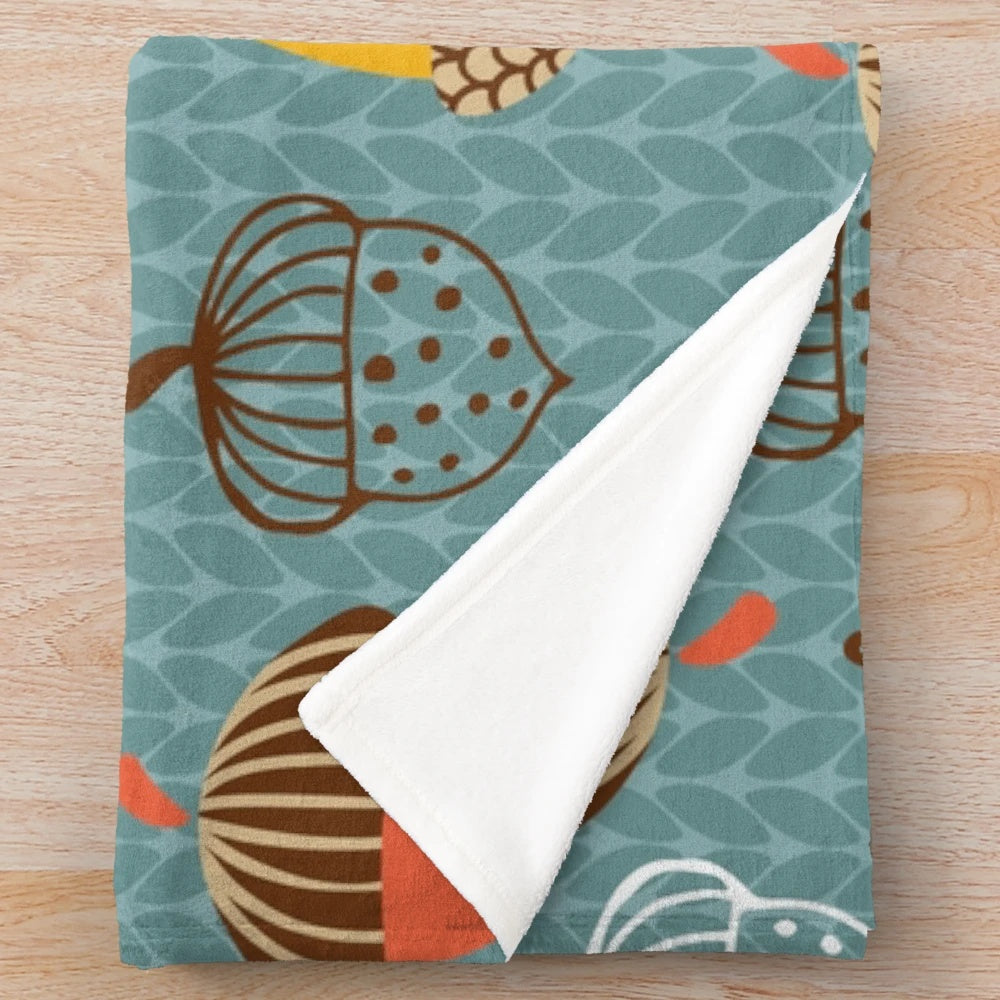 Cozy plush blanket featuring a pattern of autumn acorns