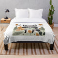 Plush blanket featuring a cute raccoon and autumn foliage design
