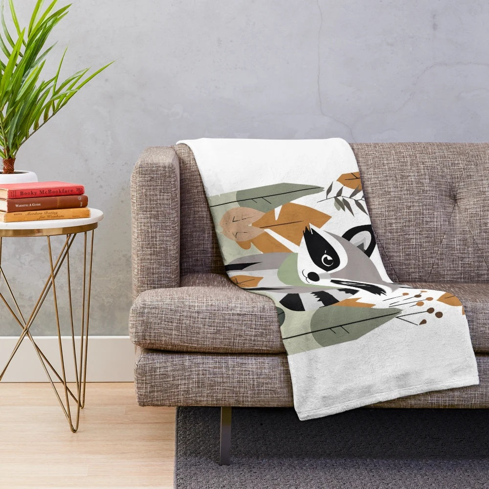 Plush blanket featuring a cute raccoon and autumn foliage design