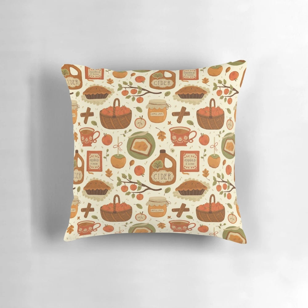 Close-up of a decorative autumn-themed pillow with apples, leaves, and a mason jar design