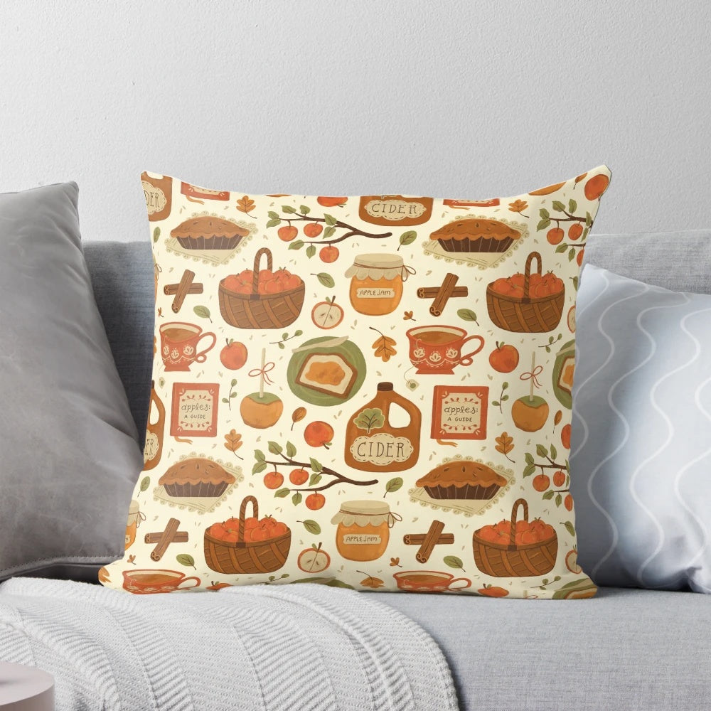 Close-up of a decorative autumn-themed pillow with apples, leaves, and a mason jar design