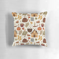 Autumn cottage-themed pillow with knit texture, pumpkins, and a teacup design, perfect for a cozy reading nook.