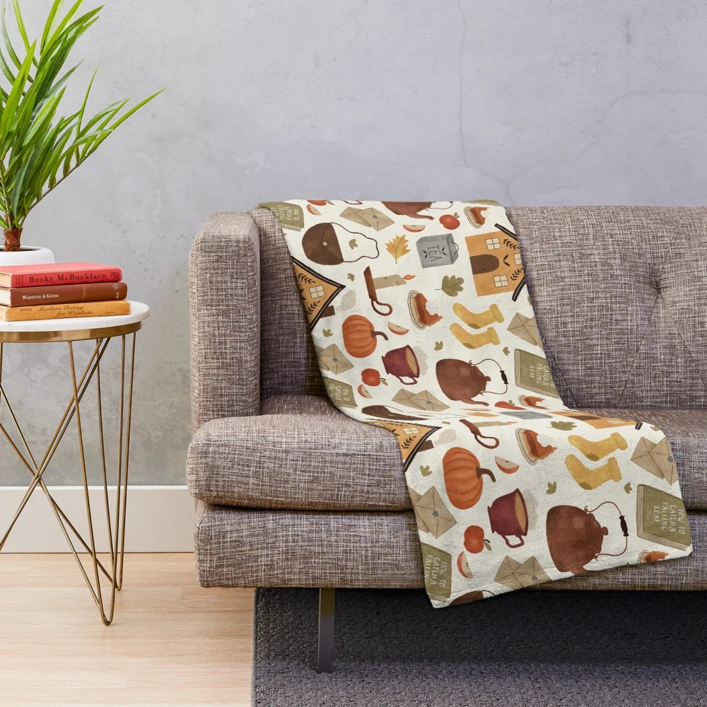 Autumn-inspired plush blanket with cozy cottage design