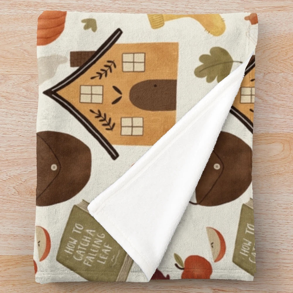 Autumn-inspired plush blanket with cozy cottage design
