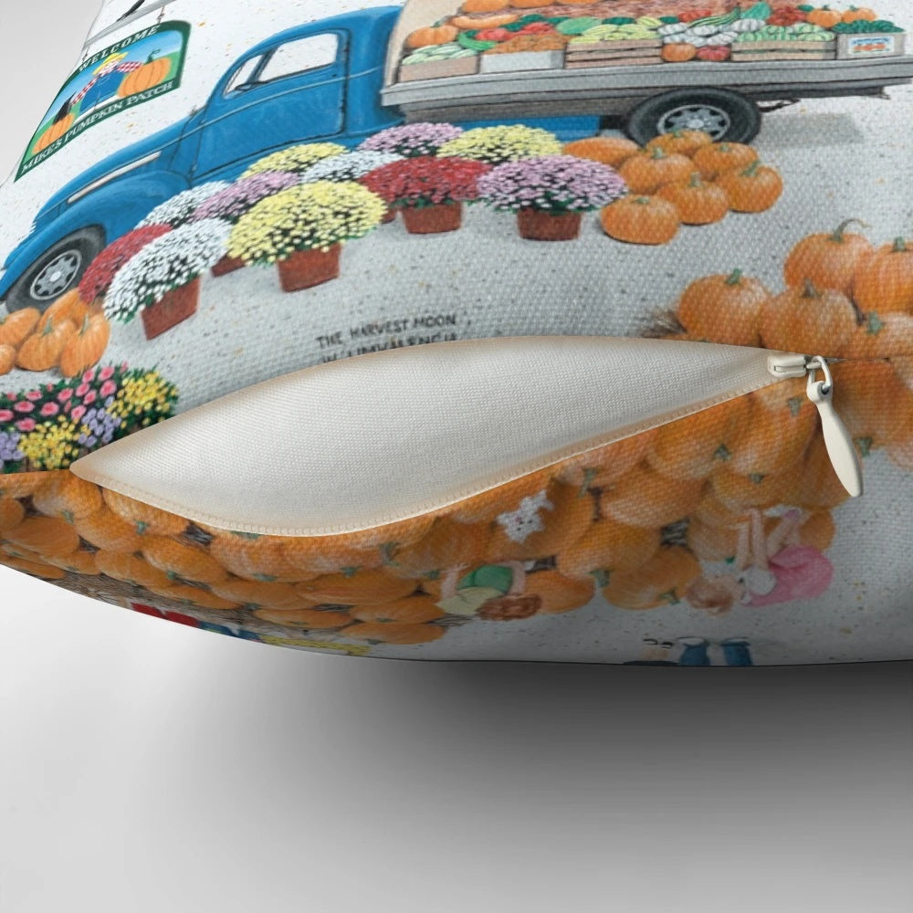 Autumn-themed pillow with pumpkins, truck, and rural landscape
