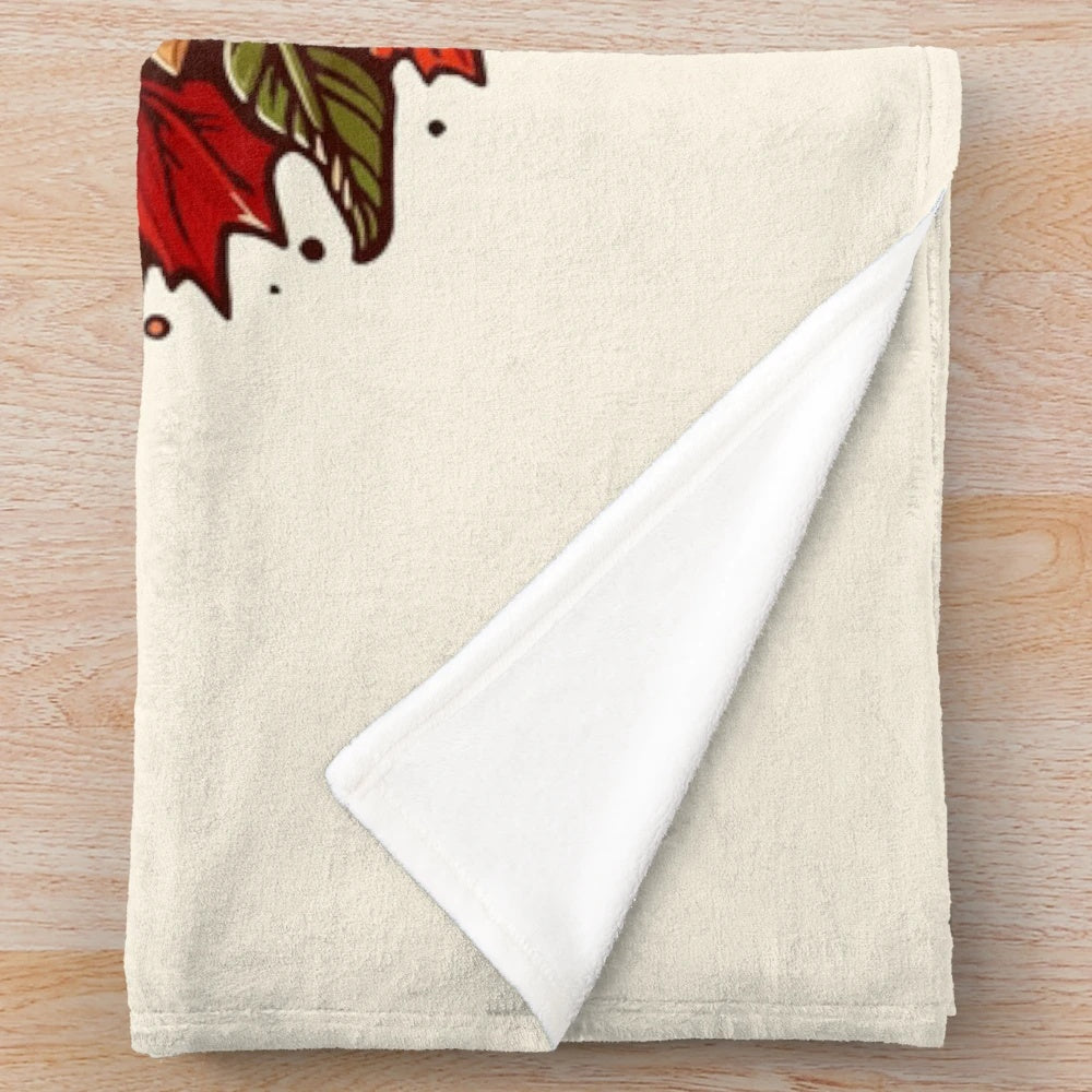 Colorful plush blanket with autumn leaves and pumpkin design