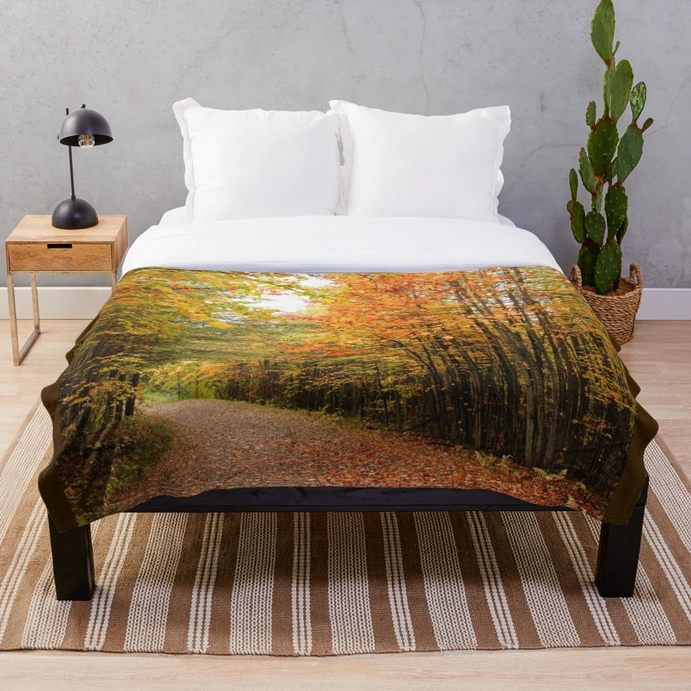 Autumn-colored plush blanket depicting a trail through a wooded forest