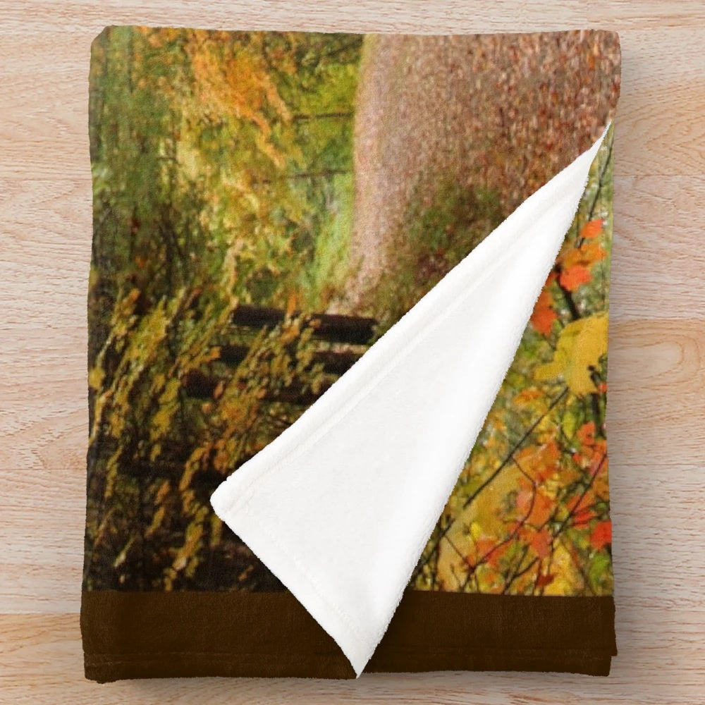Autumn-colored plush blanket depicting a trail through a wooded forest