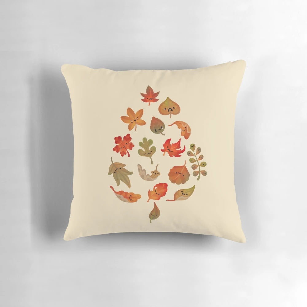 Autumn leaf pillow with cute, crying leaves in brown and khaki colors