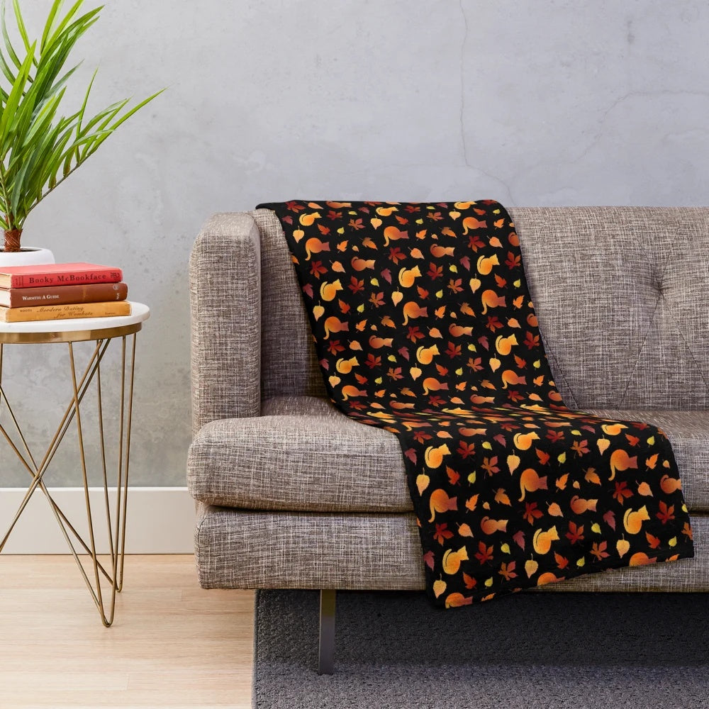 Plush blanket with a decorative fall leaves and cat pattern