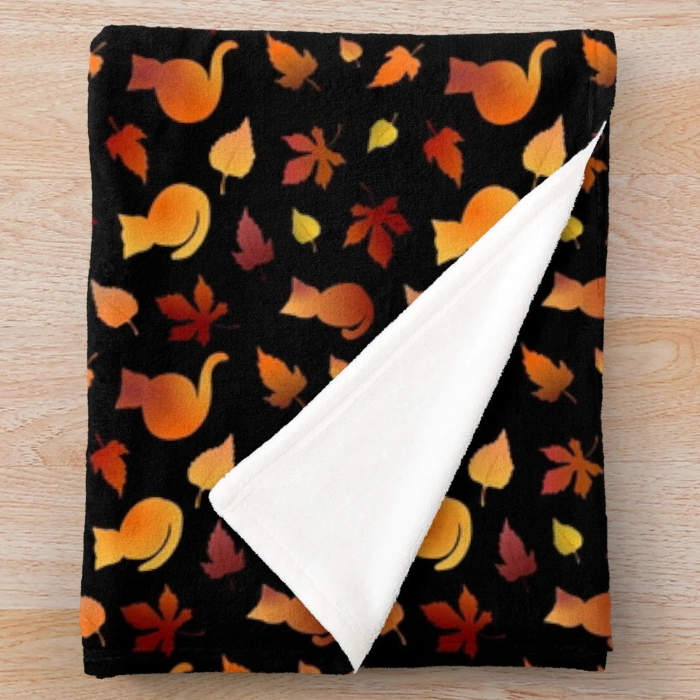Plush blanket with a decorative fall leaves and cat pattern