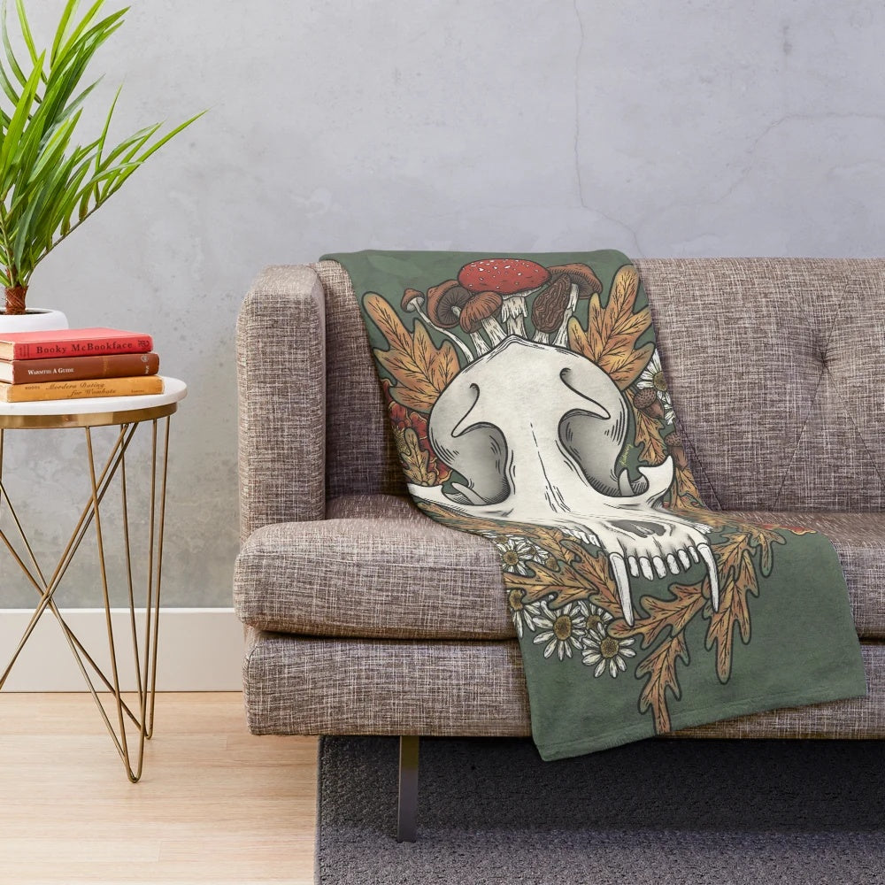 Plush blanket featuring autumn leaves and other witchy elements