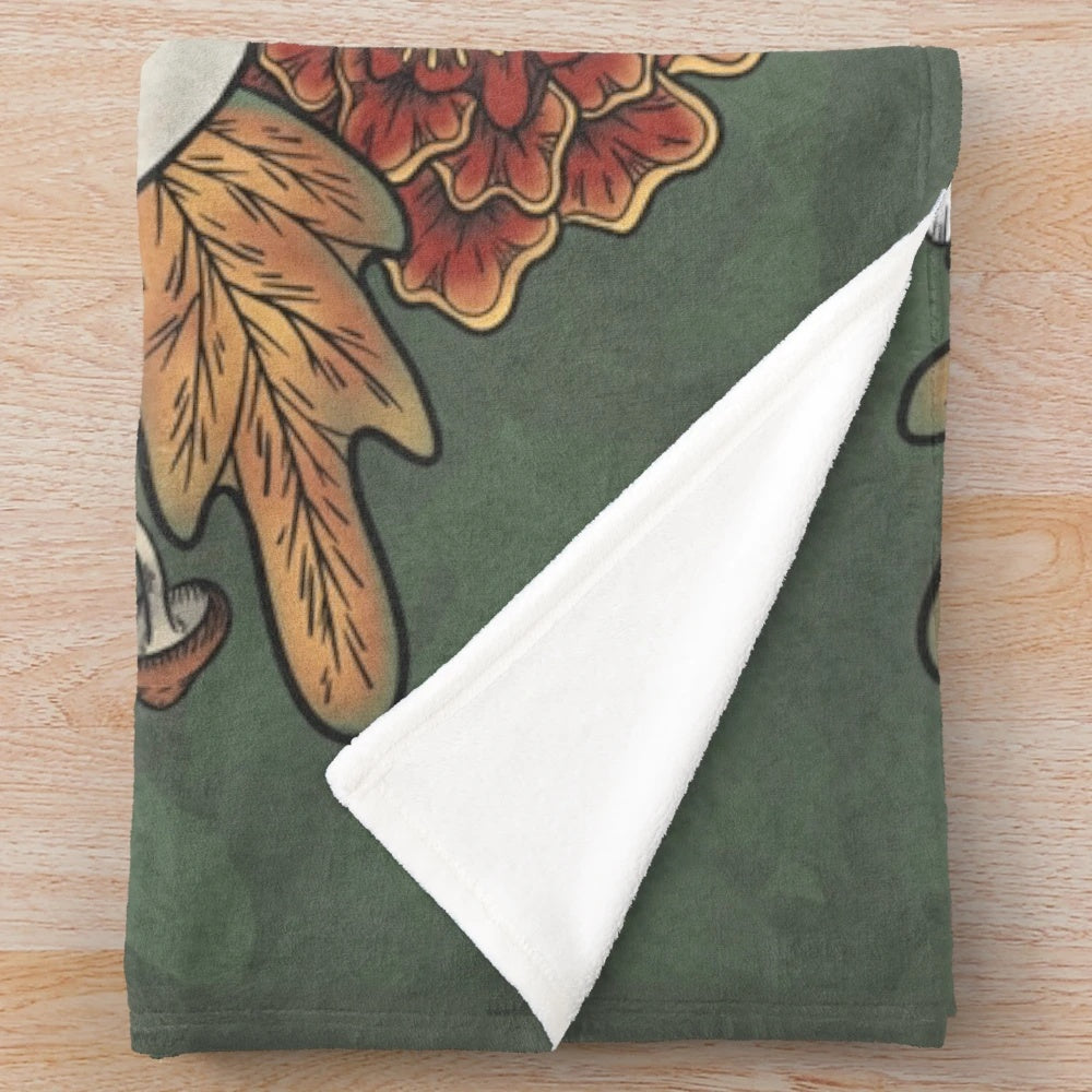 Plush blanket featuring autumn leaves and other witchy elements