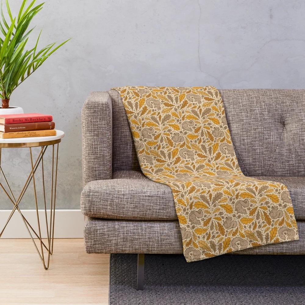 Plush blanket featuring a charming autumn nature design with oak trees and squirrels
