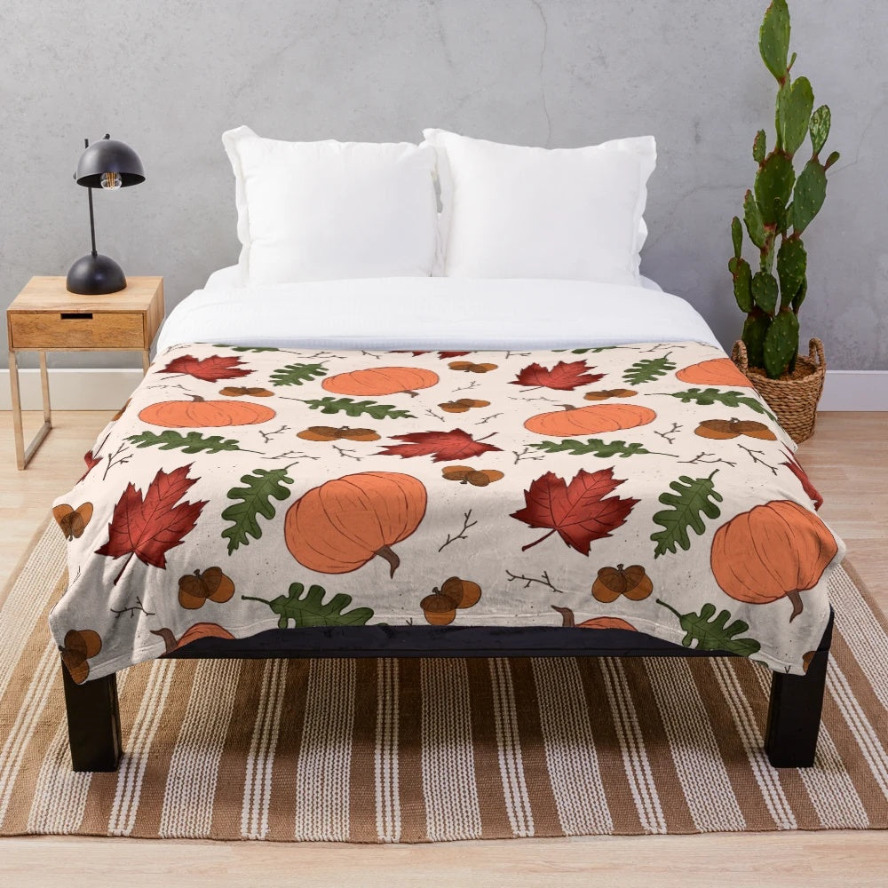 Autumn patterned plush blanket with pumpkins, acorns, and maple leaves