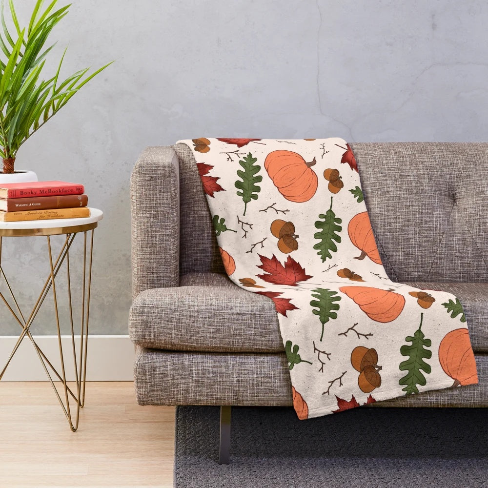 Autumn patterned plush blanket with pumpkins, acorns, and maple leaves