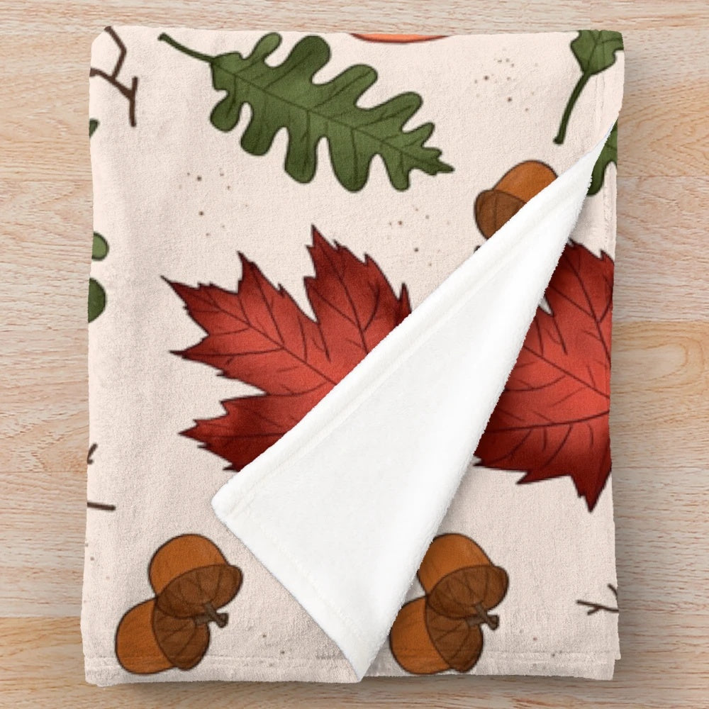 Autumn patterned plush blanket with pumpkins, acorns, and maple leaves