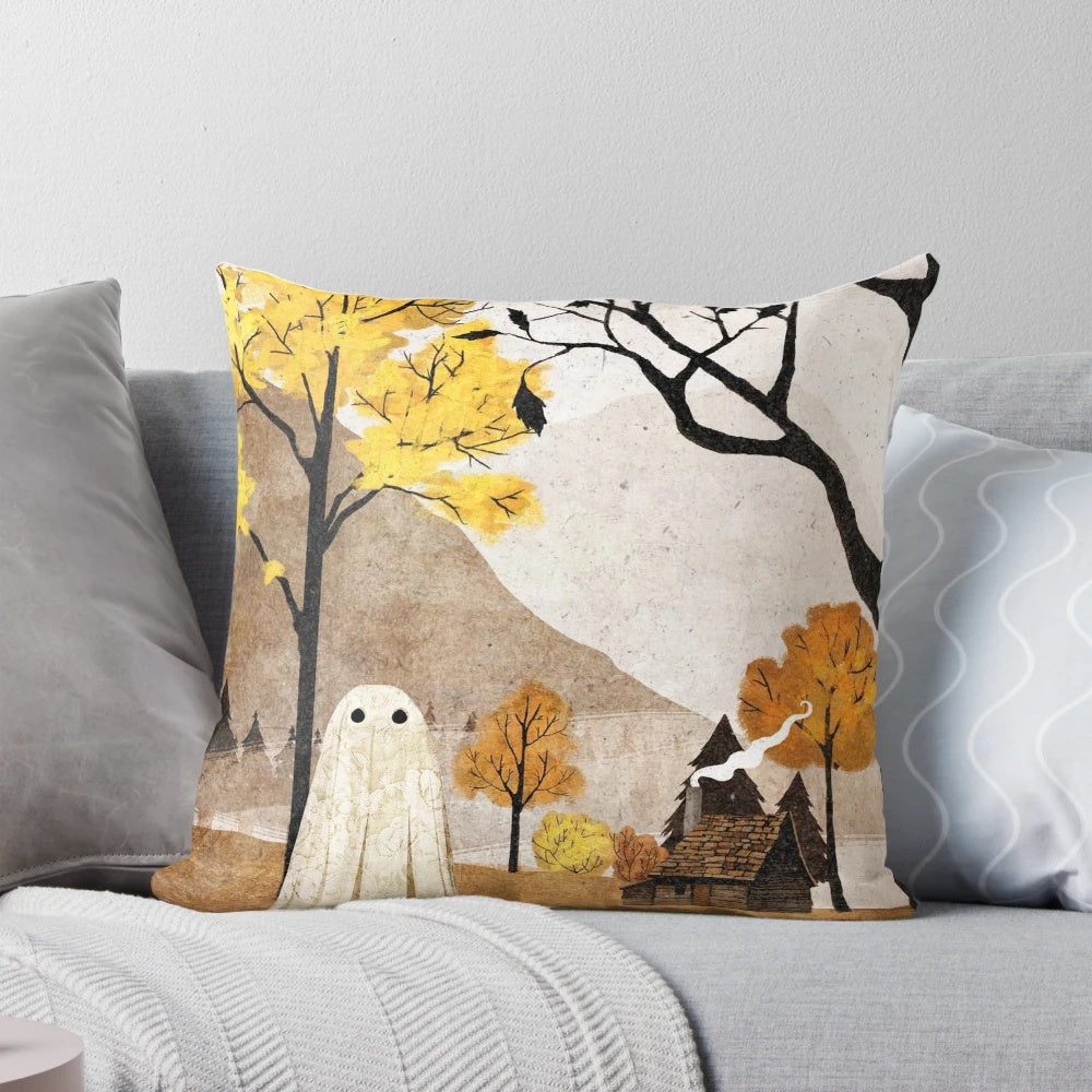 A cozy throw pillow featuring a beautiful autumn landscape with trees, mountains, and a cabin with a smoking chimney.